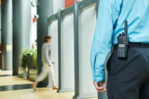 A security guard keeps a watchful eye on the entrances/exits of a building.